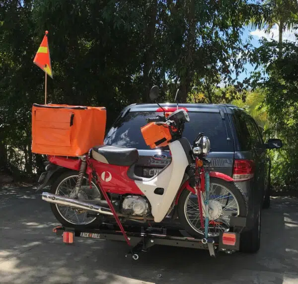 Rack N Roll's black mini carrier connected to ute with scooter loaded